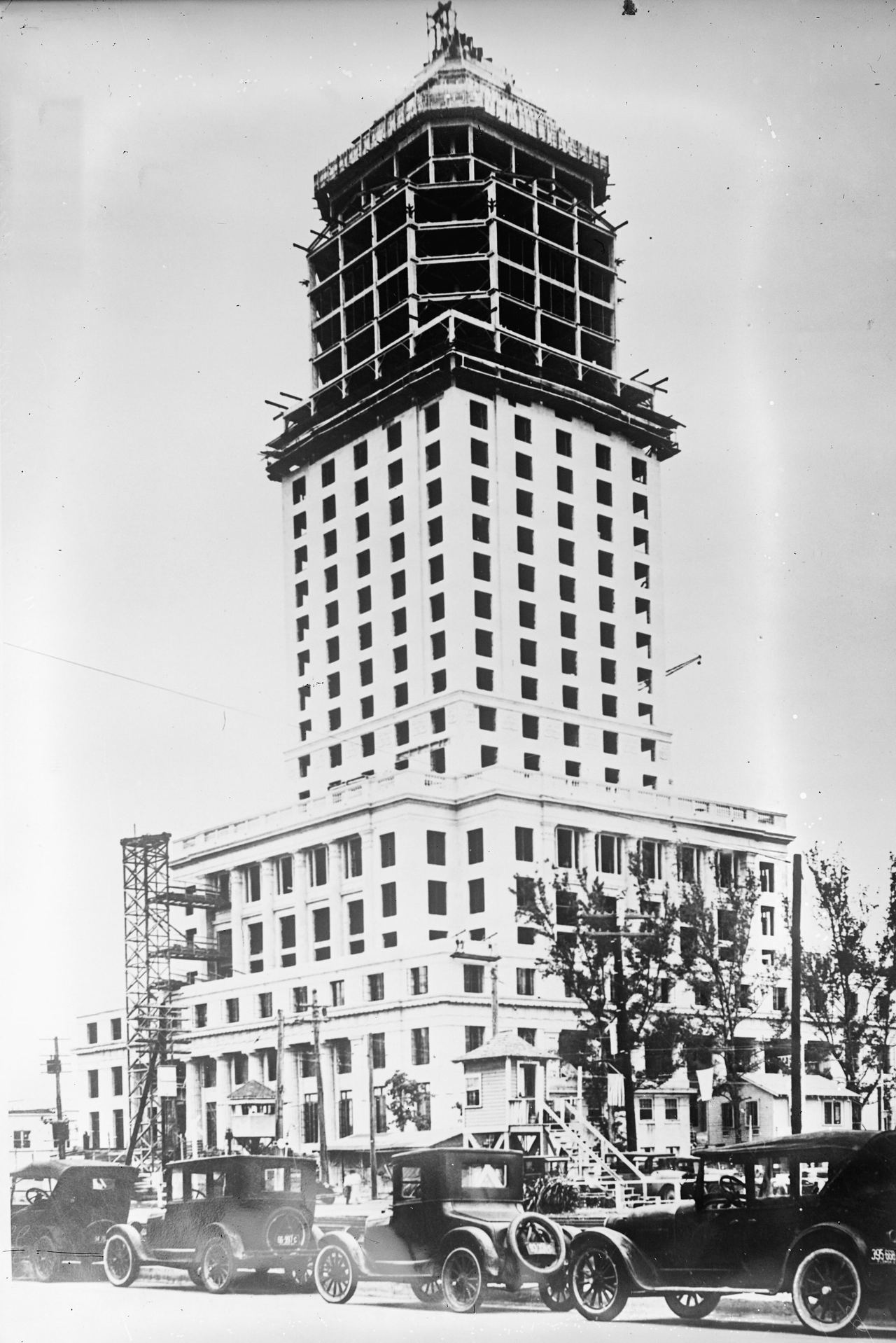 The Dade County Courthouse under construction in 1927, with cars of the period parked in front